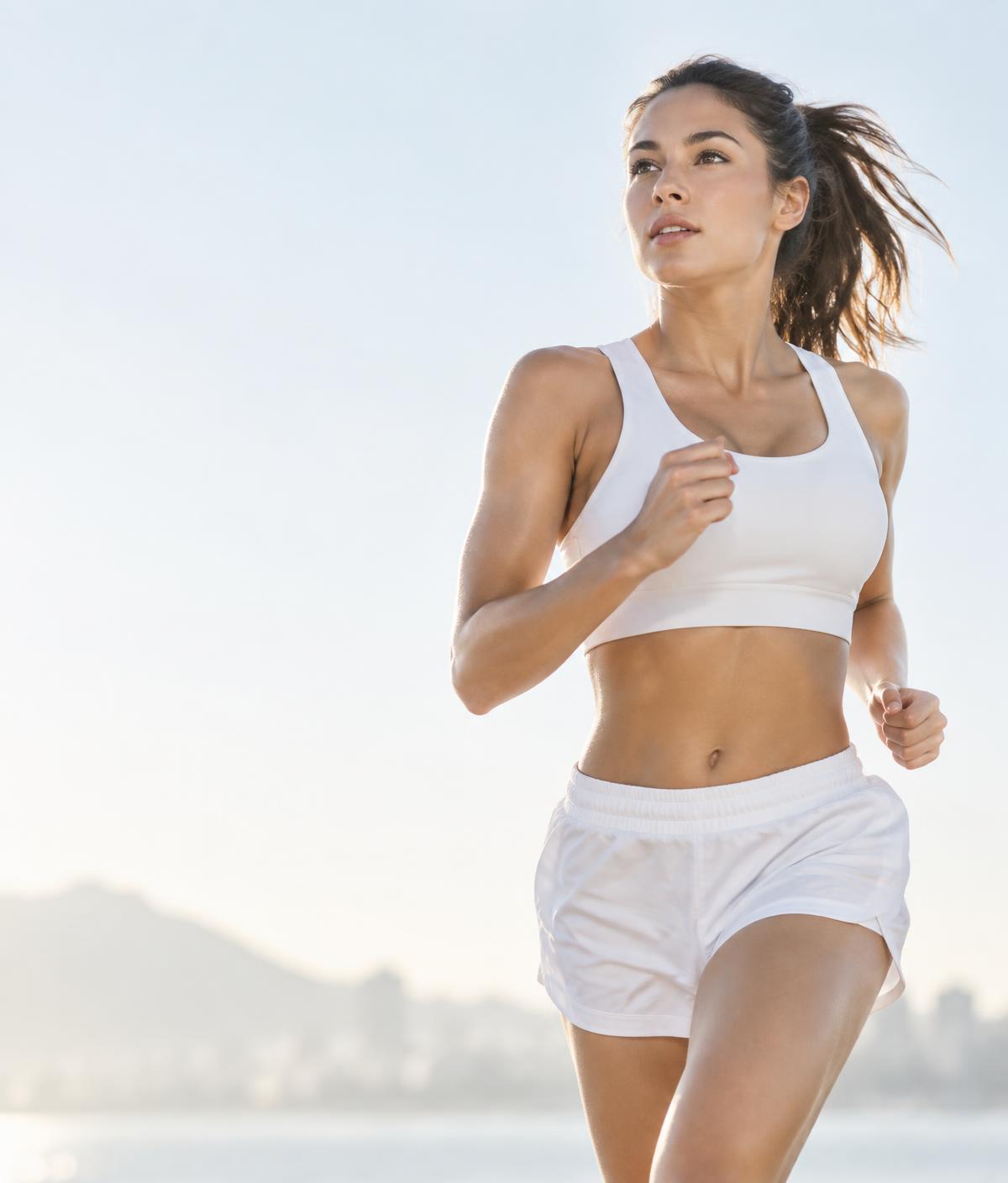 A woman running outdoors in morning light